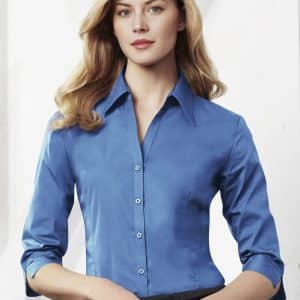 A women's button-up shirt in a vibrant blue colour with 3/4 sleeves and a fitted style, featuring a logo.