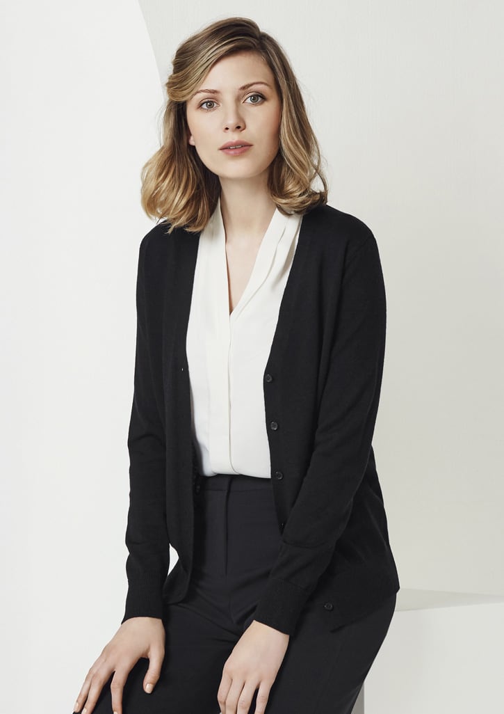A black women's cardigan featuring a button front and a soft knit texture, worn over a white blouse and black trousers.