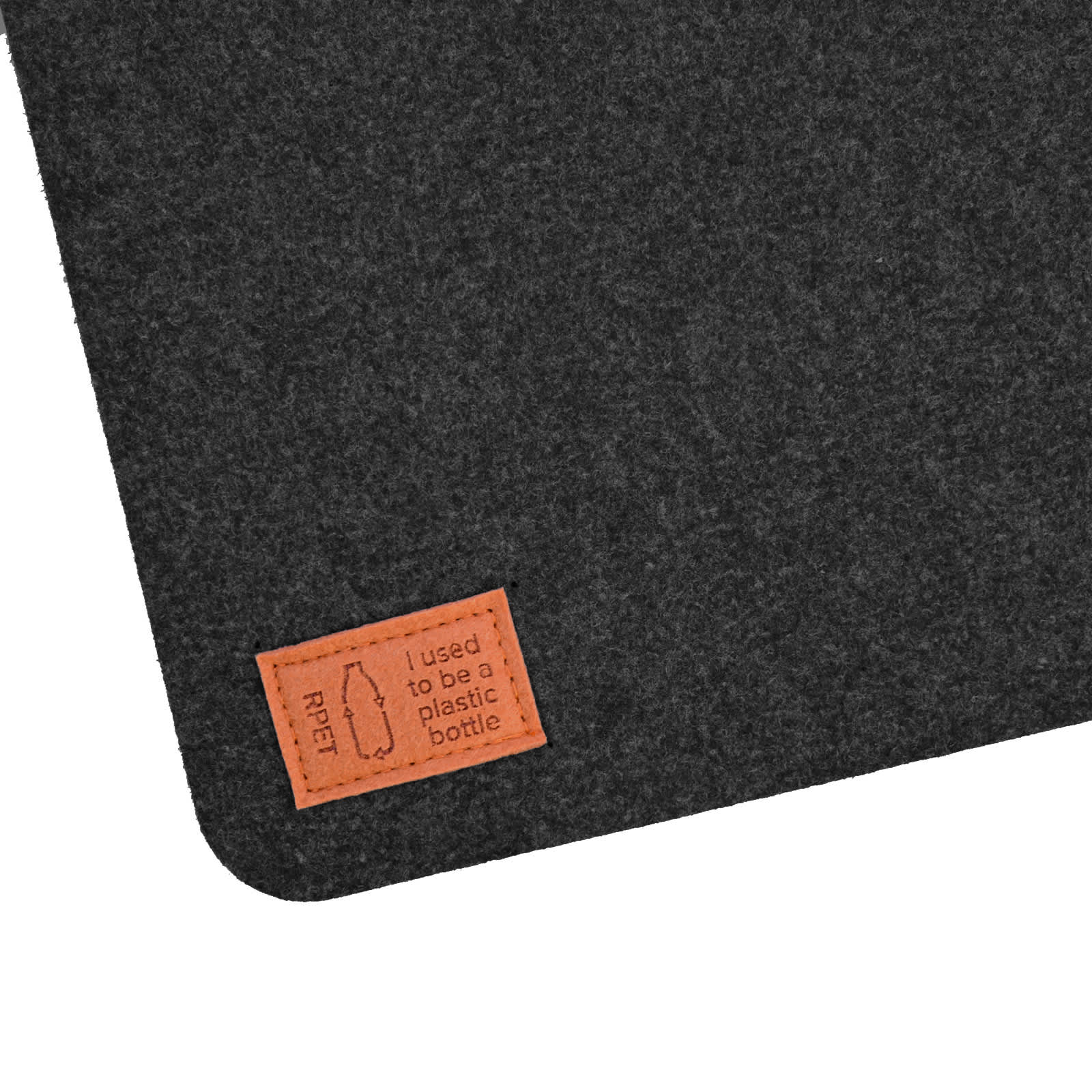A dark felt desk mat with a stitched leather tag that reads 