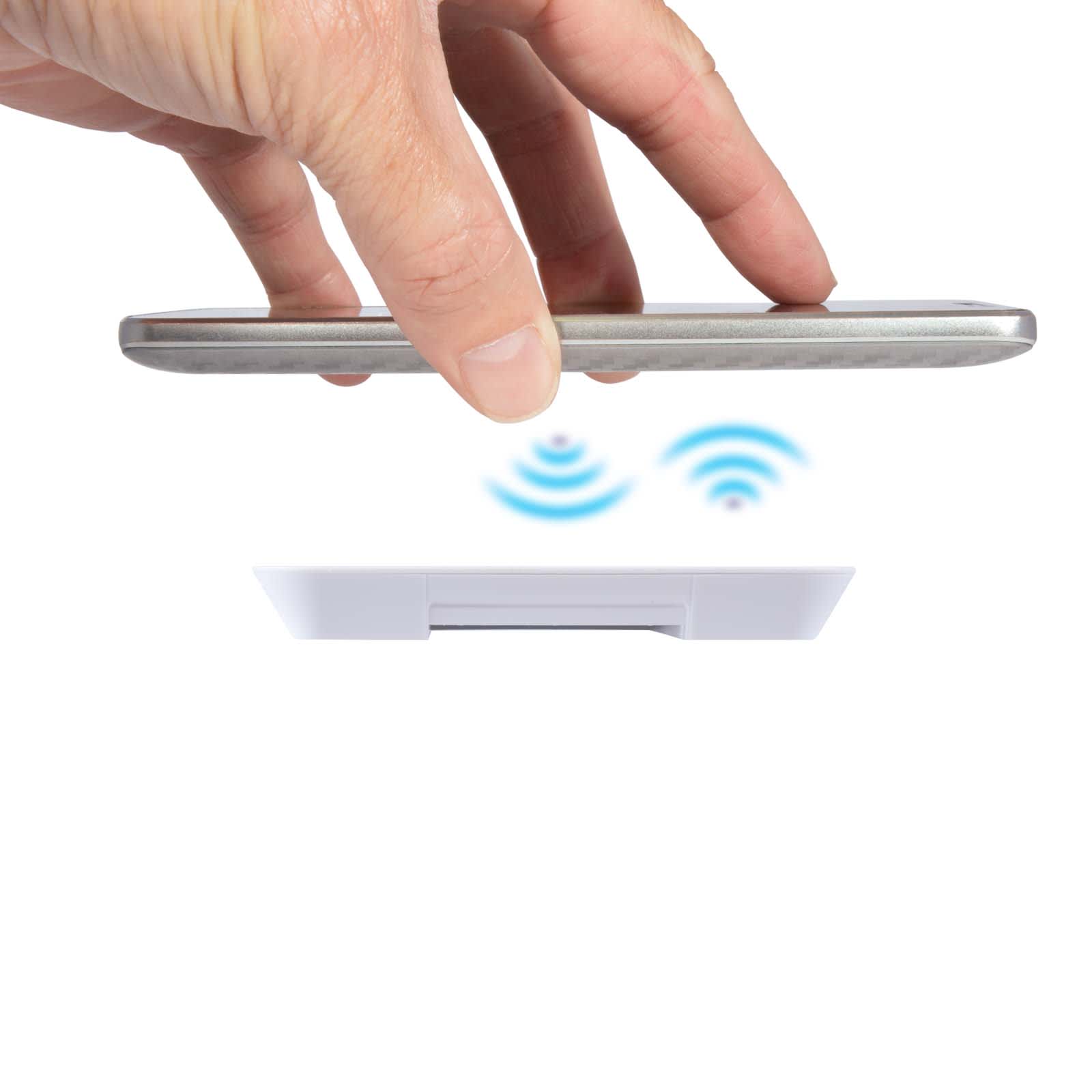 A wireless charger with a hand positioning a smartphone above it, indicated by wireless signal symbols.