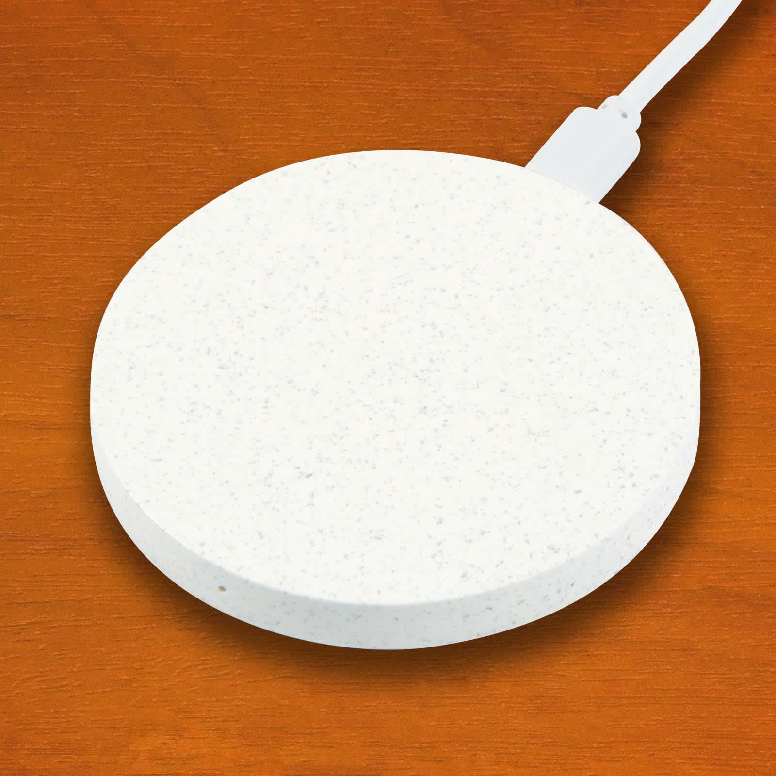 A round wireless charger with a textured white surface and a connected charging cable.