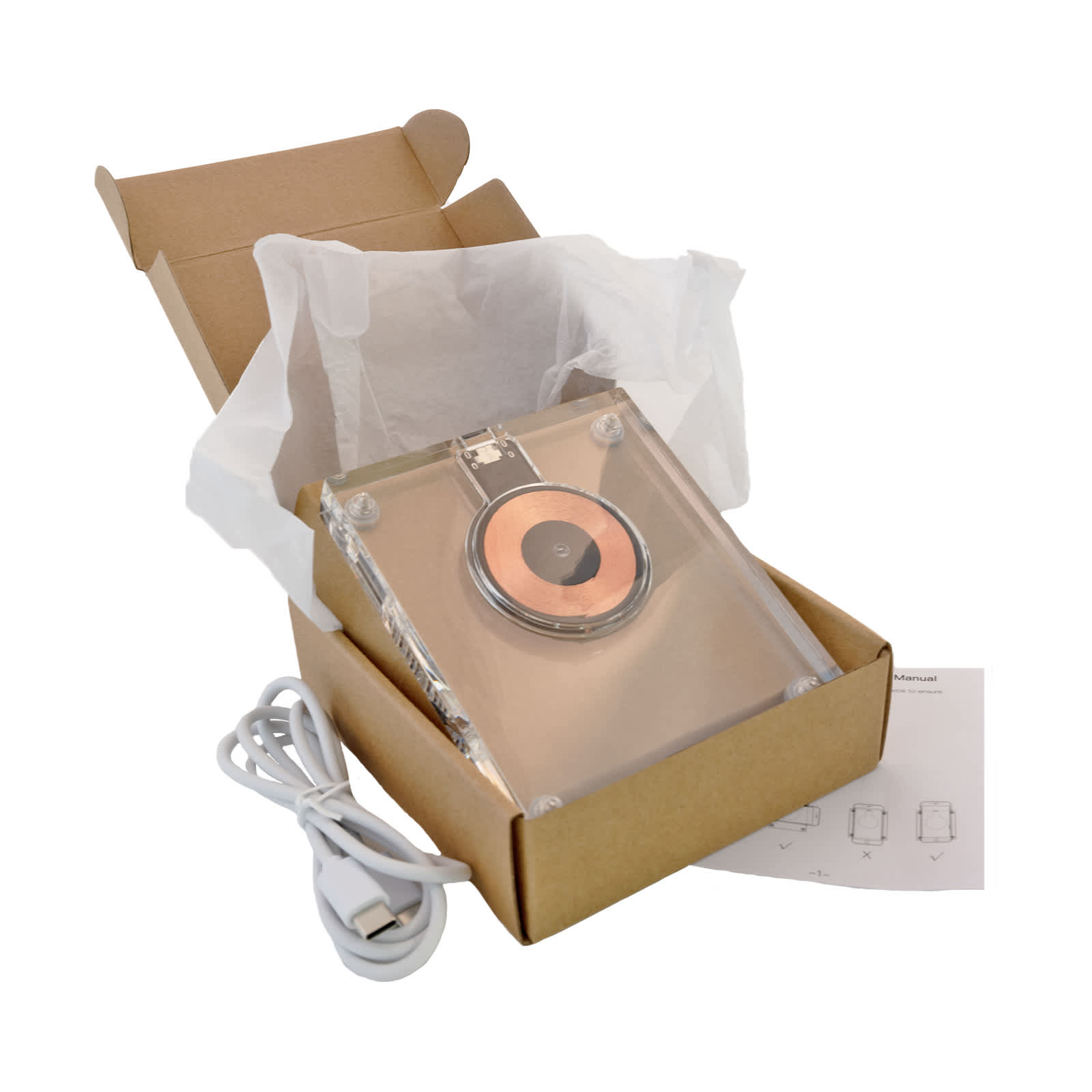 A crystal wireless charger in a box, featuring a copper charging pad, USB cable, and tissue paper.