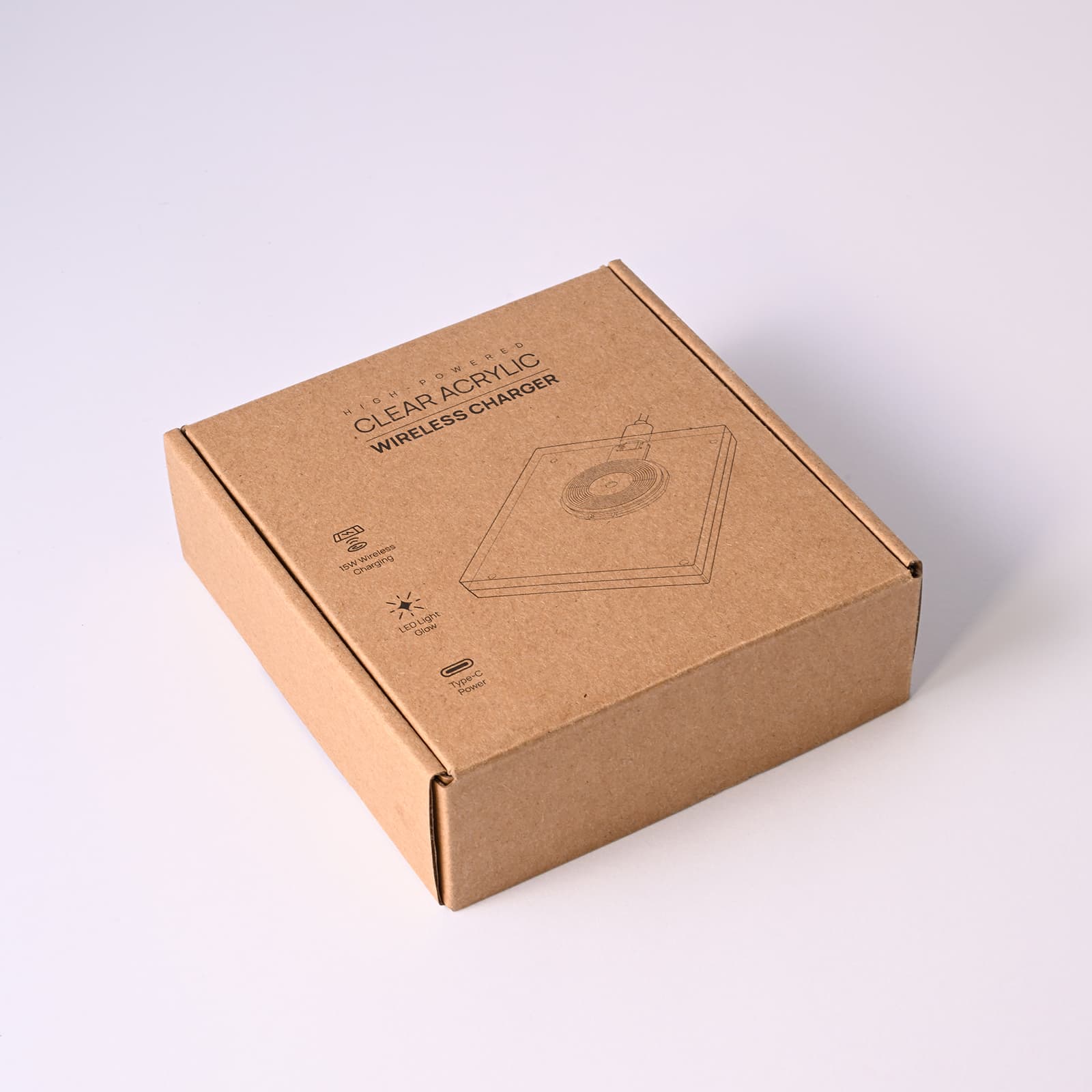 A brown cardboard box containing the Crystal Wireless Charger, featuring a simple design on the front.