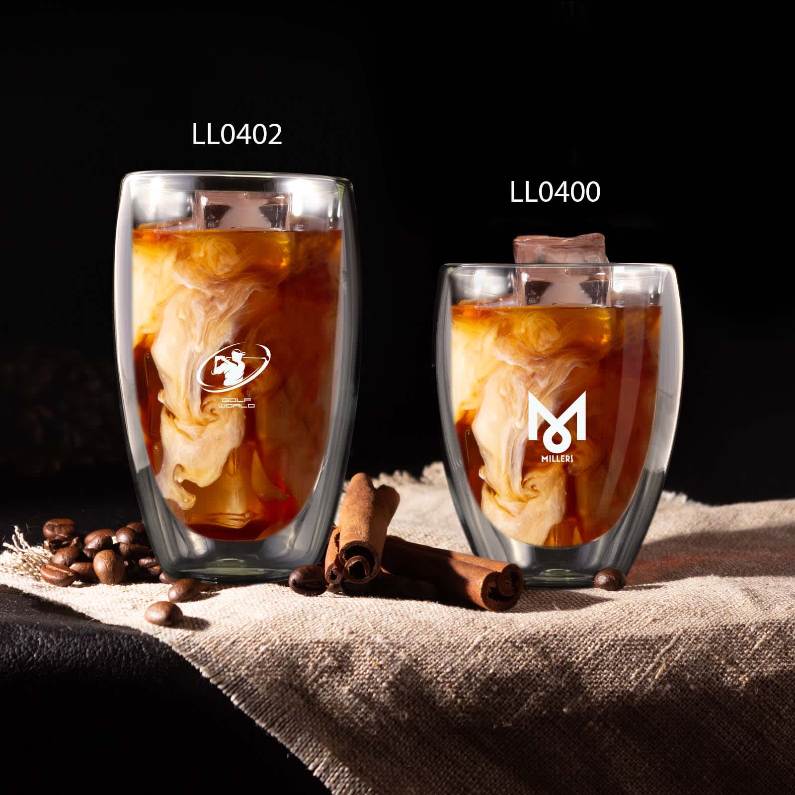 A drink bottle featuring two double wall glass cups, one dark and one light, with coffee and swirling cream, on a textured surface.