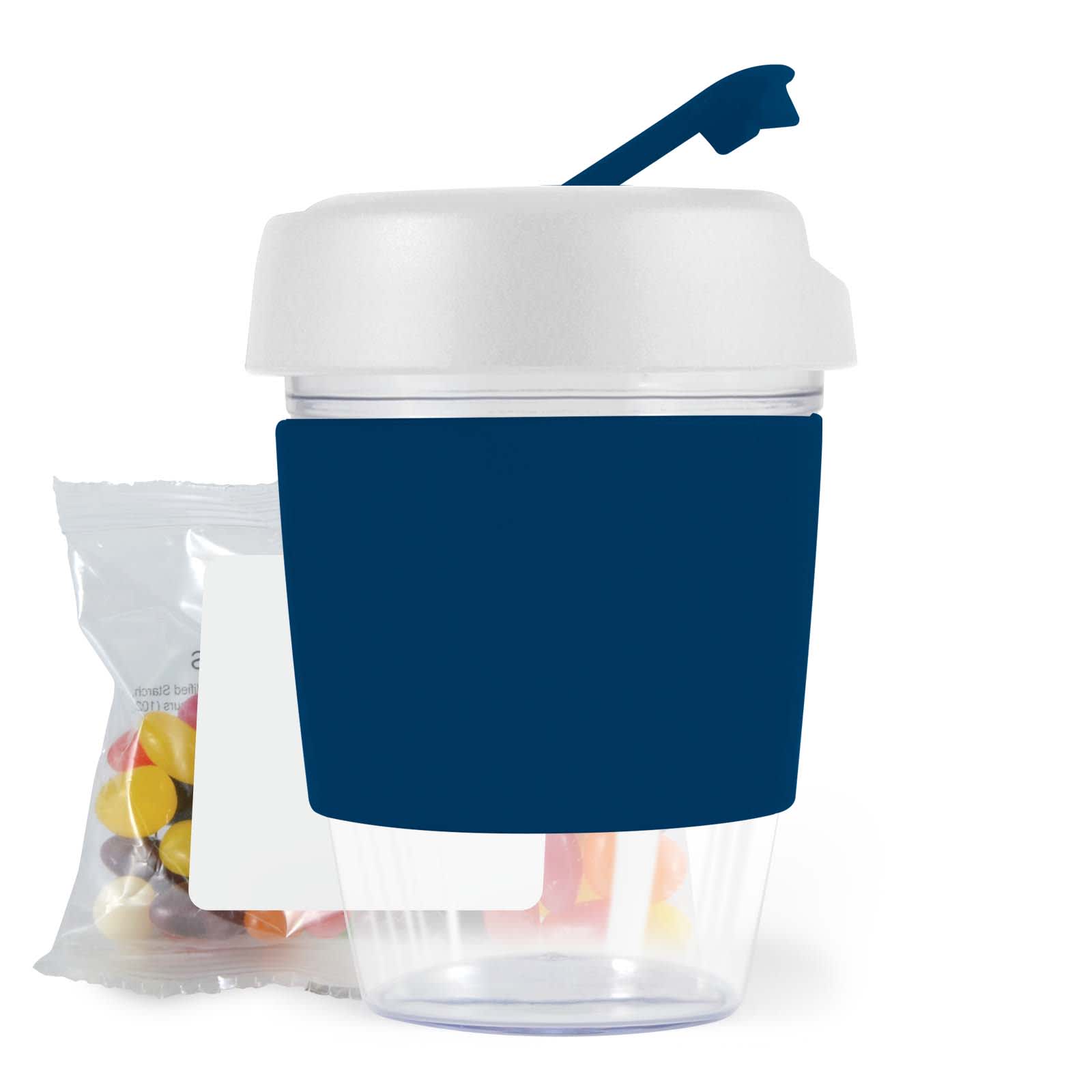 A reusable coffee cup with a dark blue sleeve and a white lid, accompanied by a pack of colorful jelly beans.