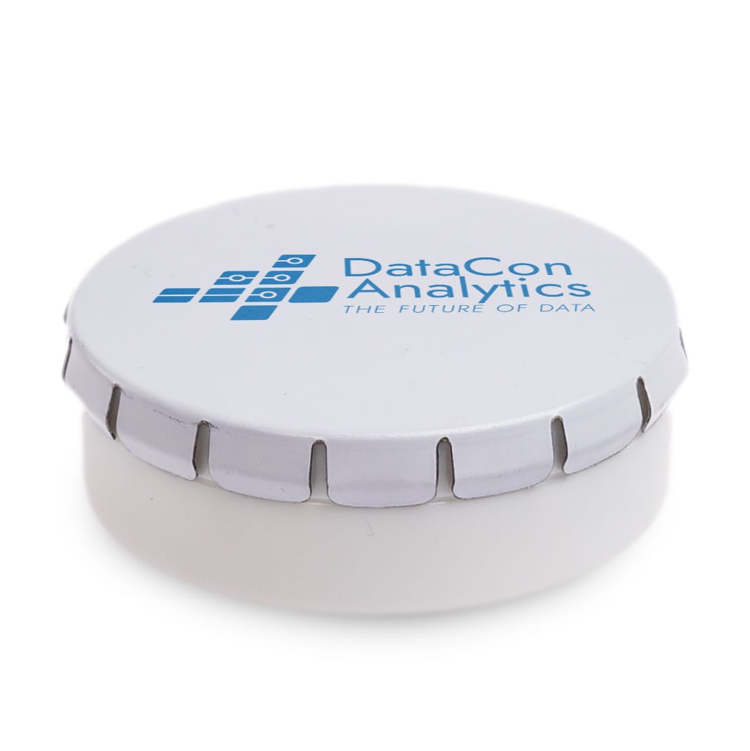 A mint tin containing small white mint tablets, with some tablets scattered around it on a light blue surface.