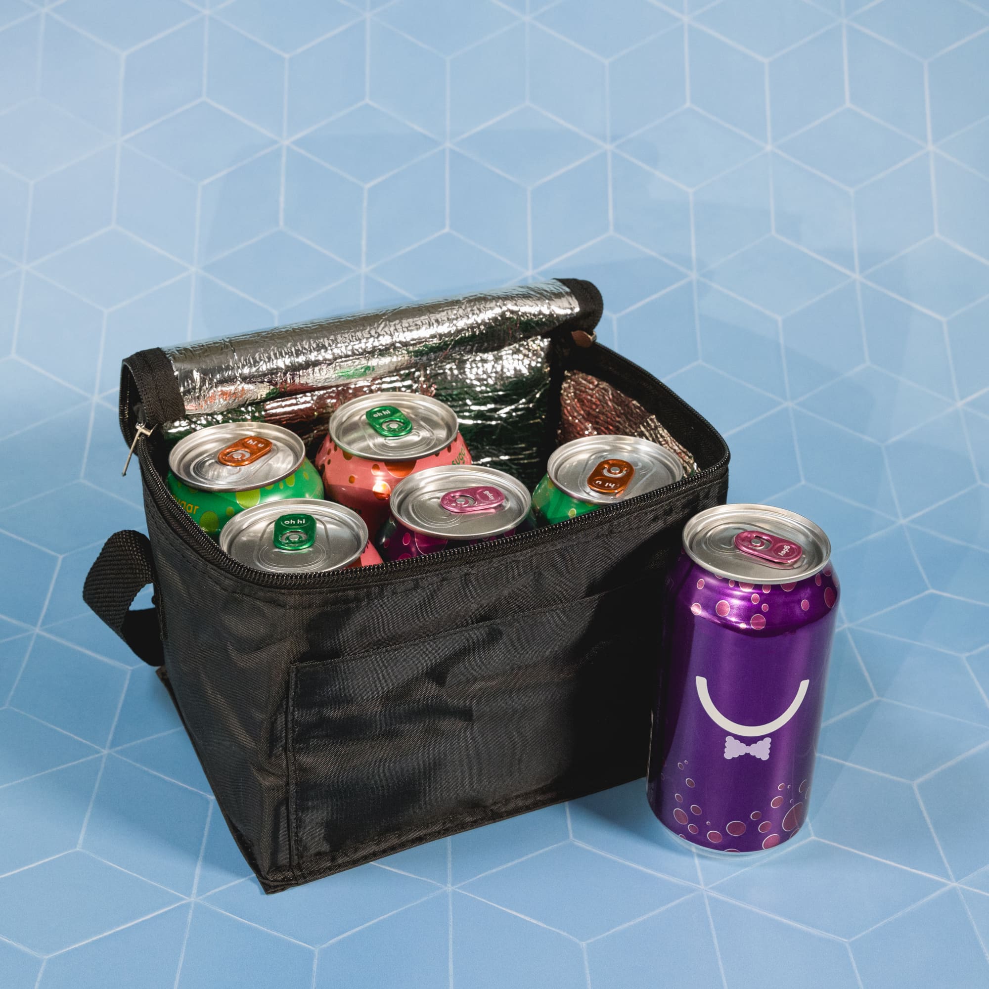 A cooler bag filled with colorful cans and a silver foil drink. The bag is black with a zippered closure.