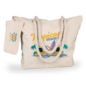 A cream canvas tote bag with rope handles, held by a person wearing denim jeans.