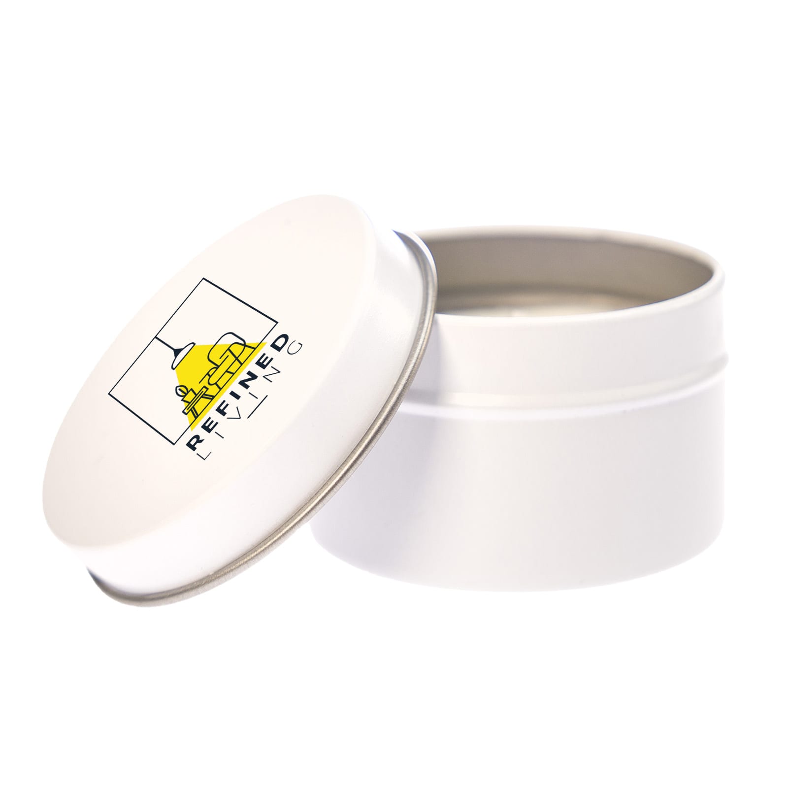A white tin candle with a metal lid, featuring a logo on the top. The candle is unlit and inside the tin.