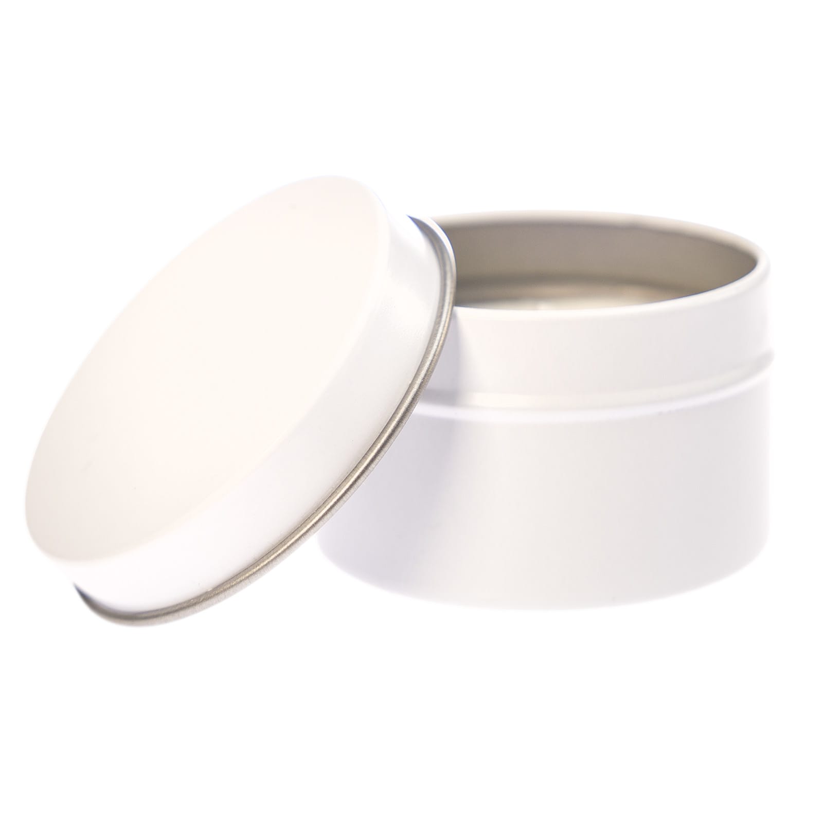 A petite black candle in a tin, featuring a removable lid and a candle wick.