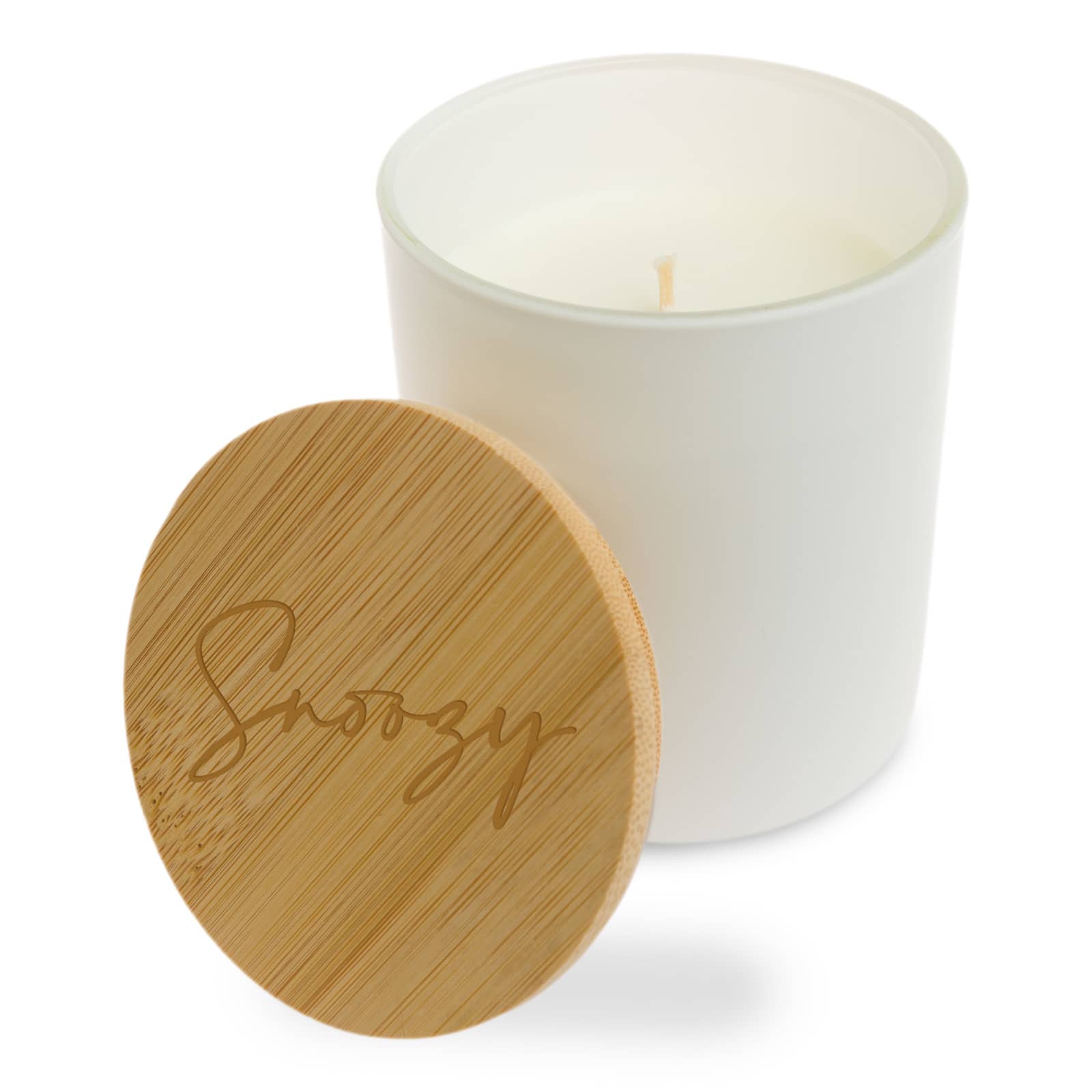 A natural soy candle with a warning label on the bottom, detailing safety instructions.