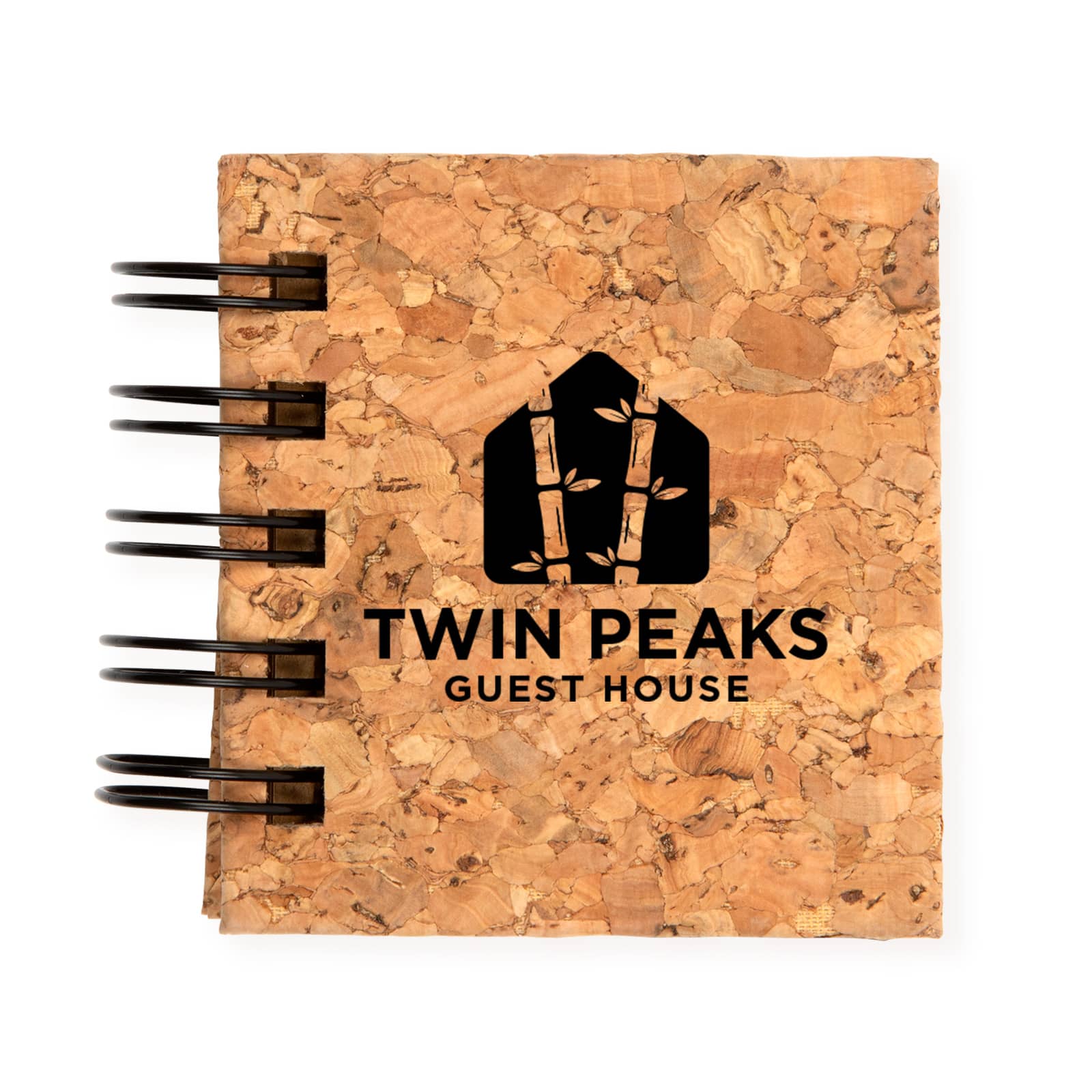 A cork notebook featuring a black spiral binding and the logo for 