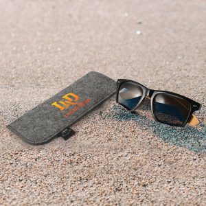 A pack of Ultra Sunglasses featuring a sturdy case. The sunglasses have a stylish black frame with dark lenses.