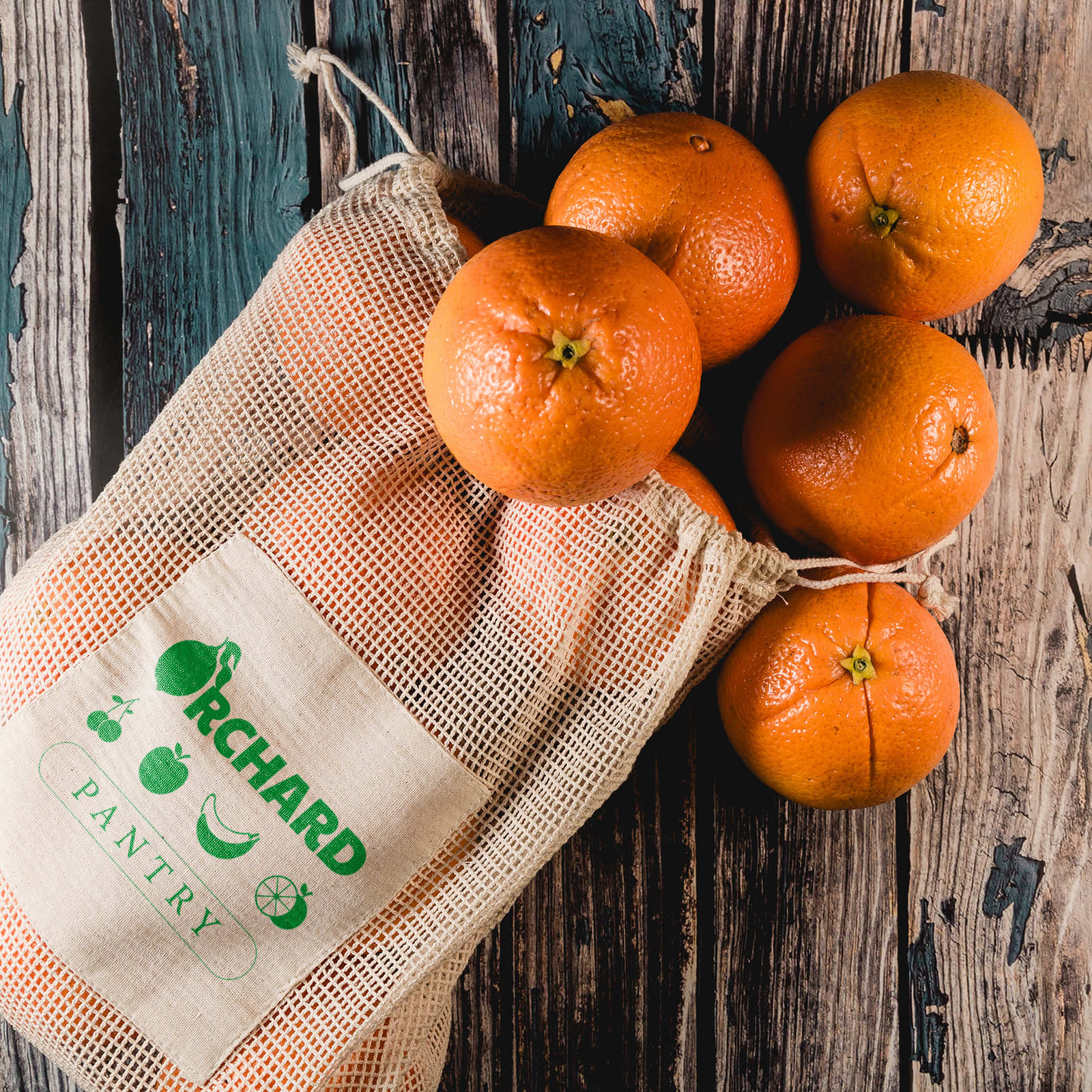 A mesh produce bag containing multiple oranges, with the words 
