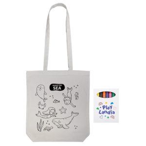 A cotton tote bag in off-white, featuring outlined sea creatures and children, with an attached branding label.