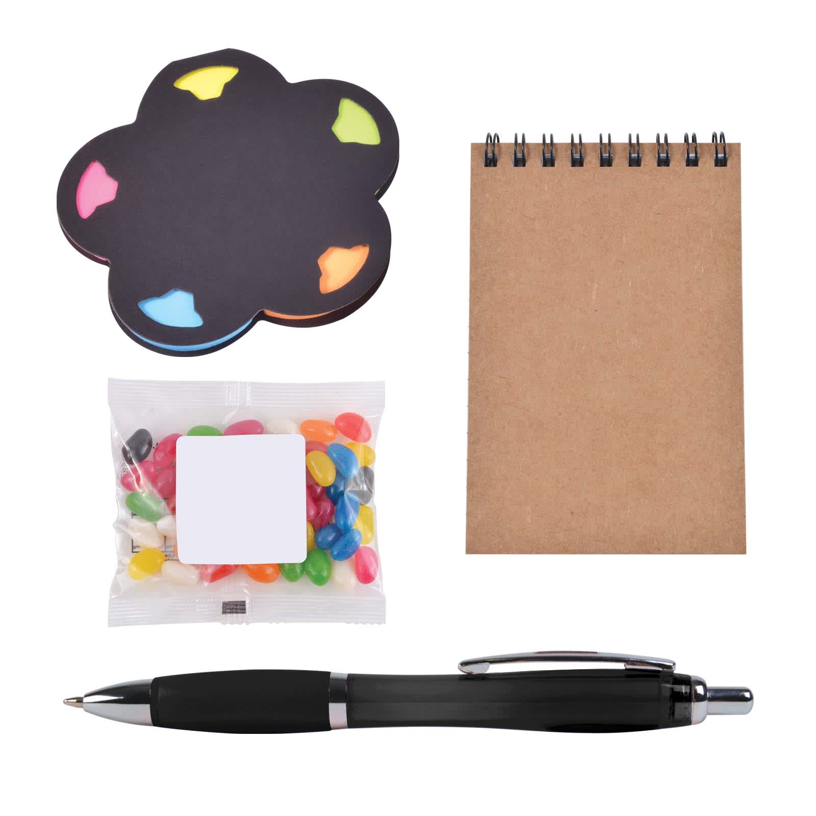 A cloud-shaped sticky note pad, a notepad, a pen, and a pack of colorful jelly beans. All items are neatly arranged.