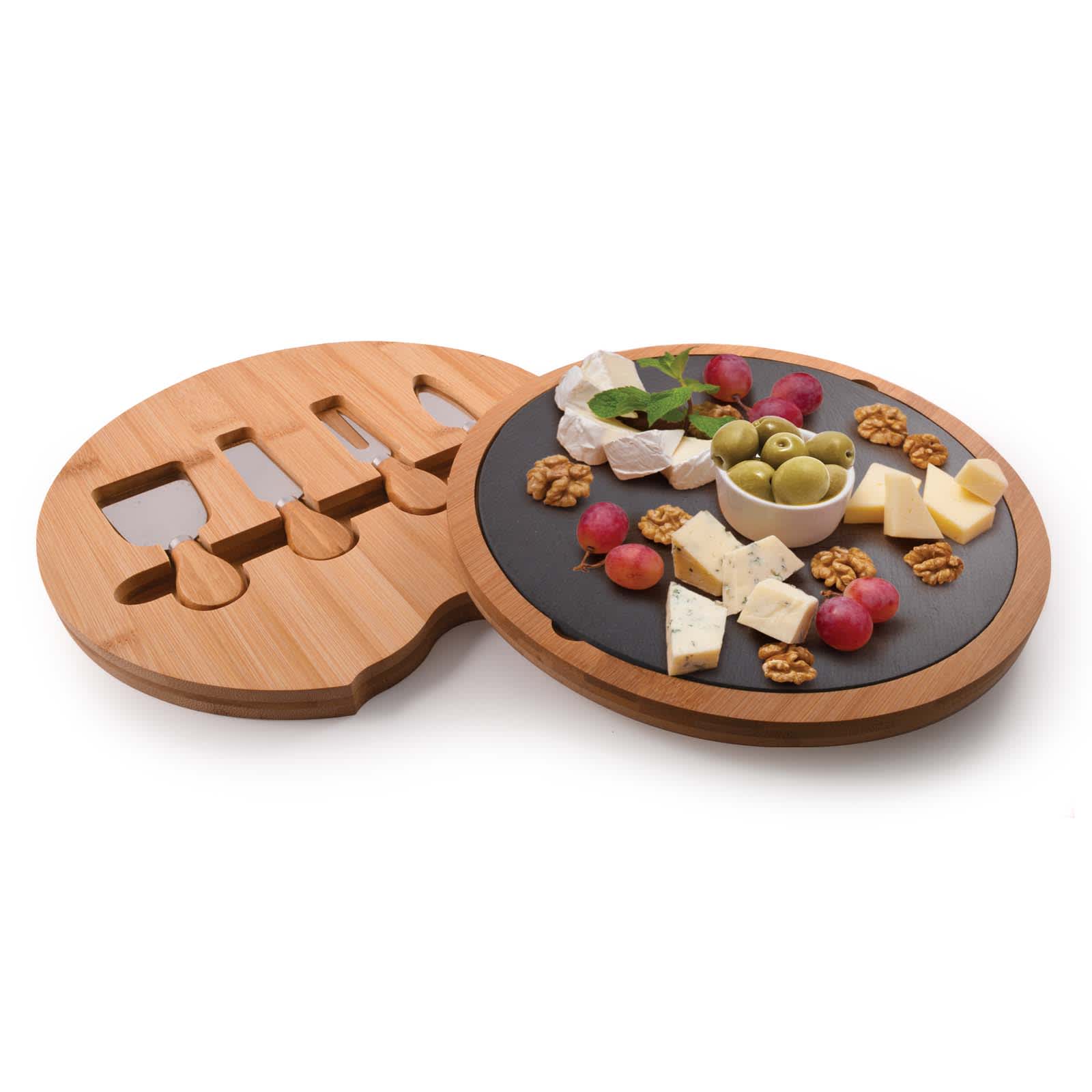A bamboo cheese board with a black slate surface, featuring assorted cheeses, nuts, grapes, and olives. It includes a knife set.