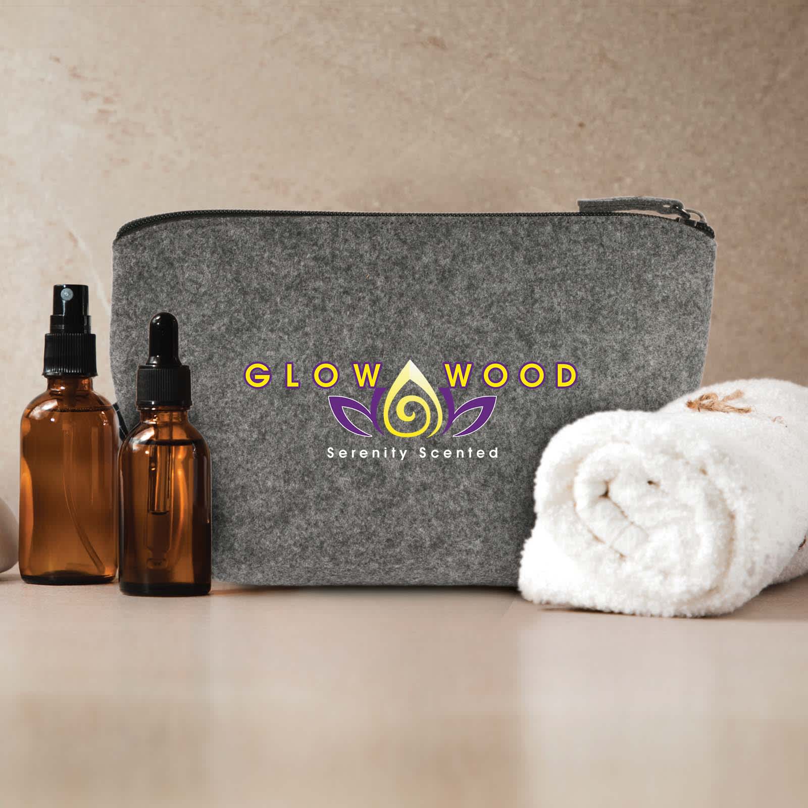 A grey felt pouch with a logo, alongside sunglasses, a smartphone, and a charging cable.