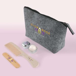 A gray cosmetic pack with a zipper, featuring a comb, two containers, and a logo.