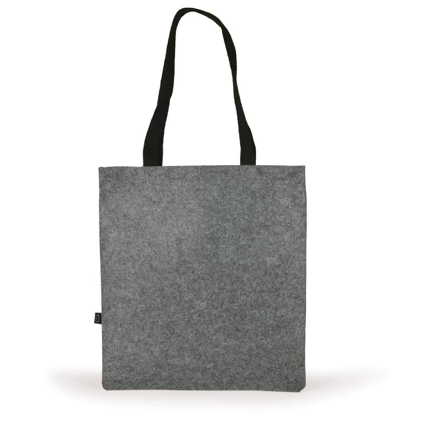 A grey felt tote bag with black handles, held by a hand. The bag features a logo or branding.