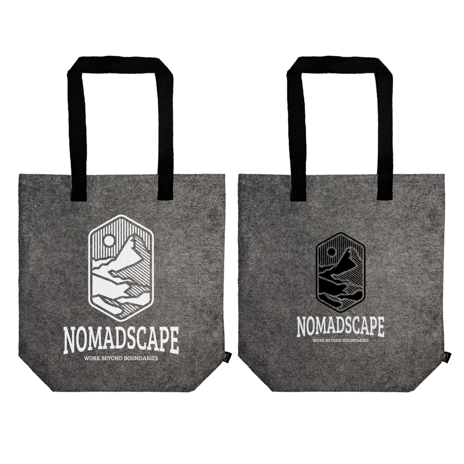 A grey tote bag with black handles, displayed by a person holding it by the straps. The bag has a logo.