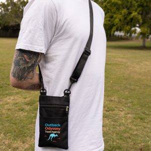 A black neck pouch worn crossbody, featuring multiple pockets, with a model dressed in casual attire.