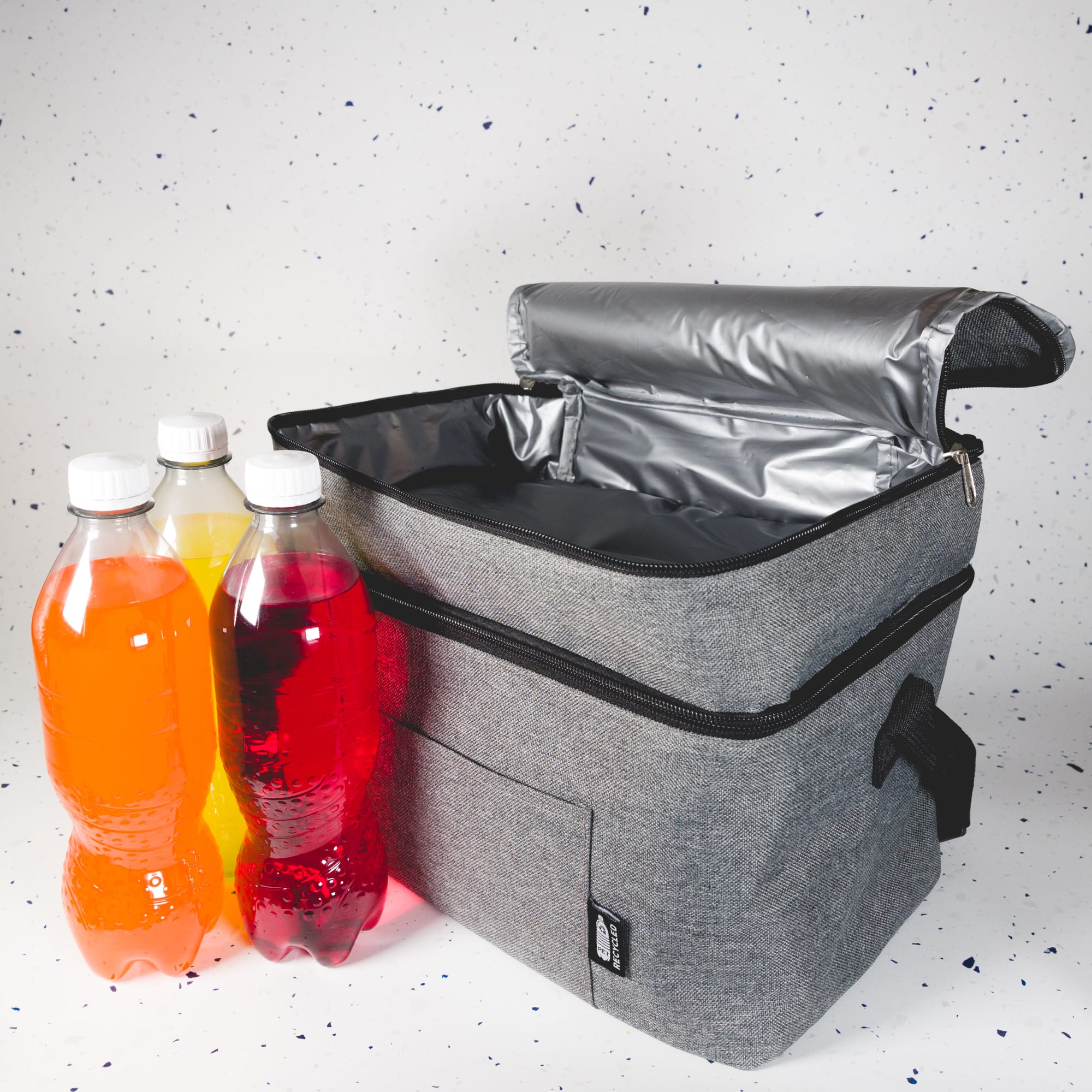 A cooler bag in gray with a zippered top, accompanied by three colorful bottles in orange, red, and yellow.