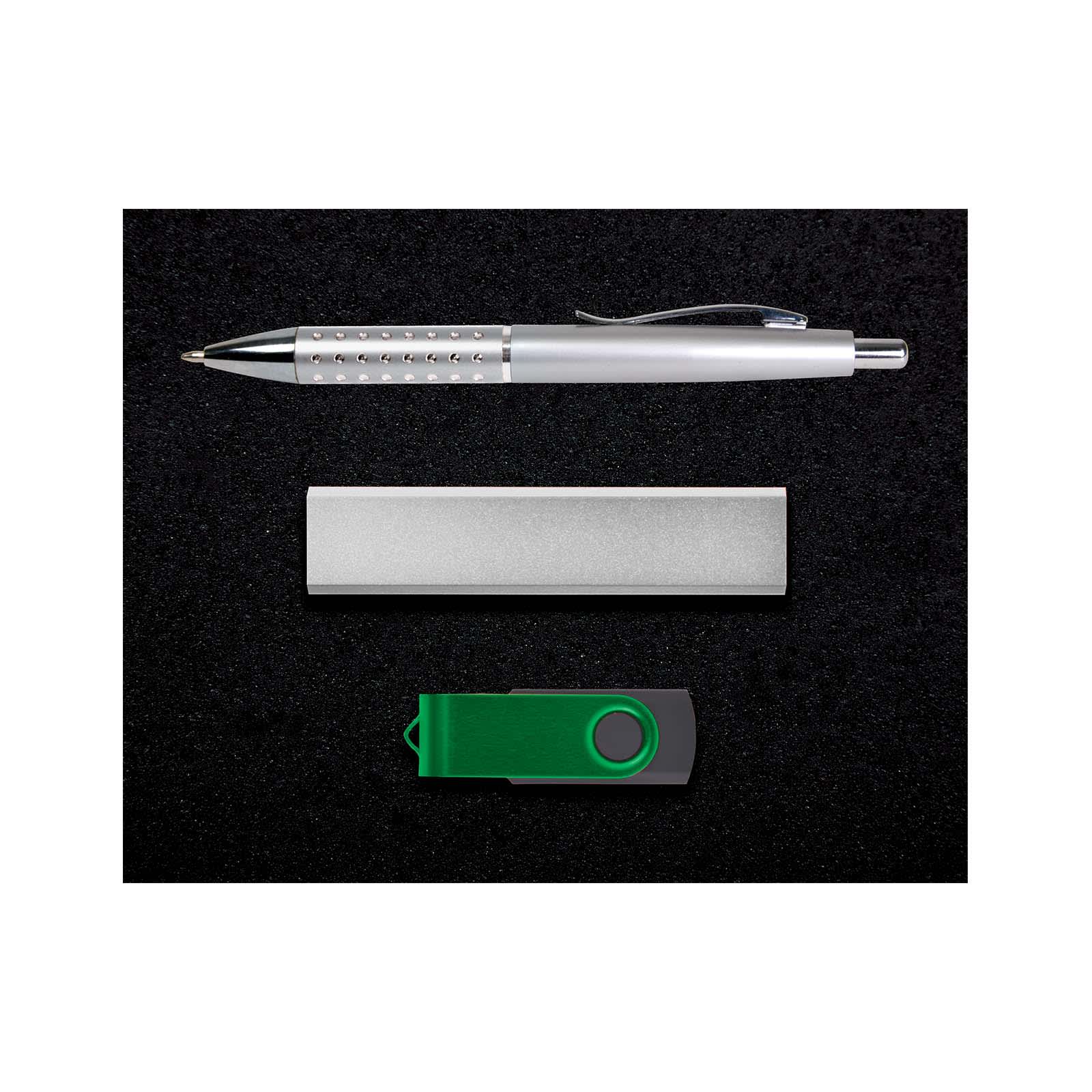 A silver pen, a silver USB drive, and a green USB flash drive arranged on a black background.