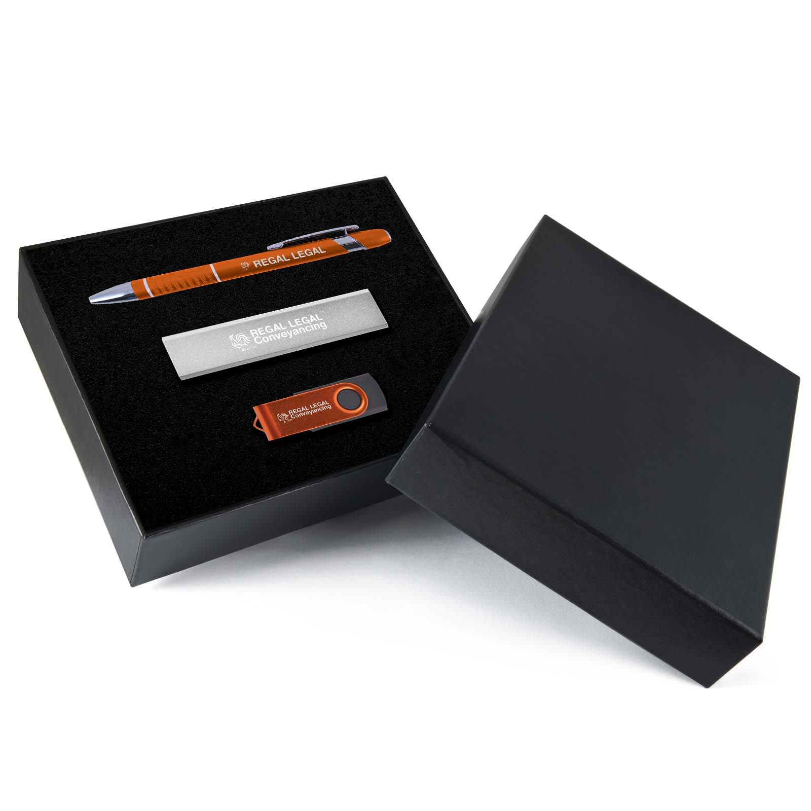 An orange pen, a silver metal plate, and a USB drive in a black gift box.
