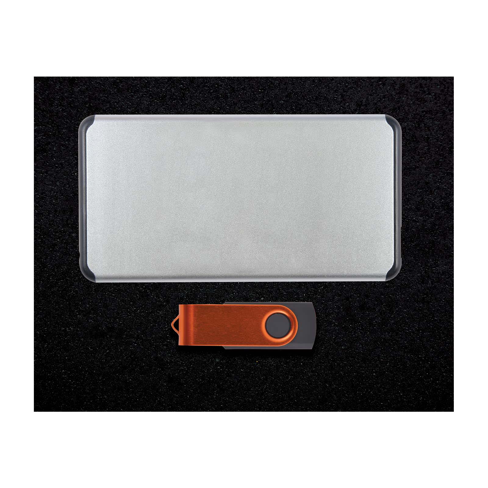 A silver power bank with a sleek design and an orange USB drive beside it, presented on a dark surface.