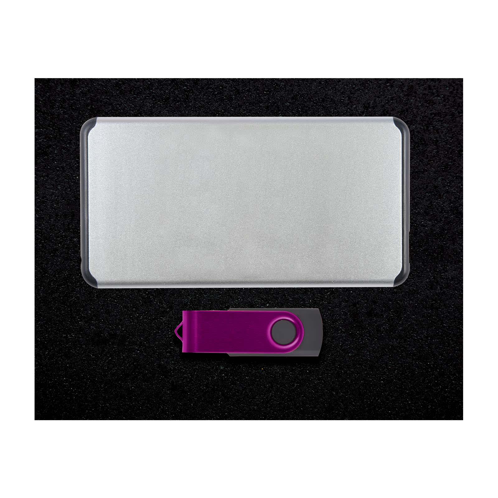 A silver power bank and a purple USB drive are presented together on a black surface. The set includes a logo.