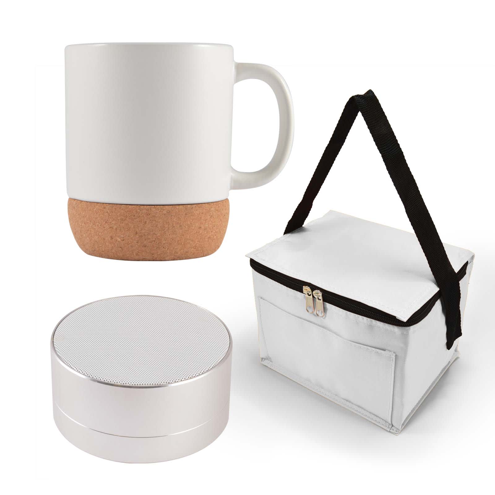 A coffee mug with a cork base, a small speaker, and a white carrying case with a black strap.