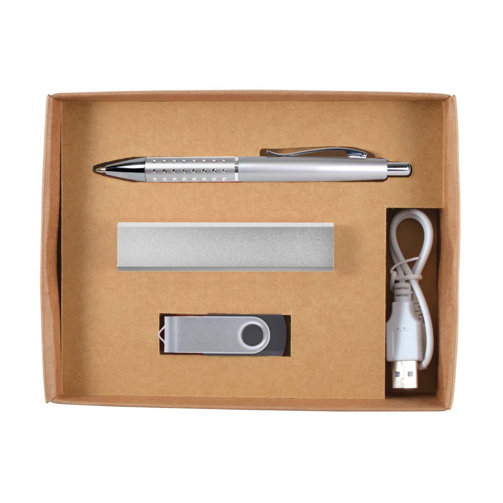 A cardboard gift set containing a silver pen, a metal USB flash drive, a silver power bank, and a USB charging cable.
