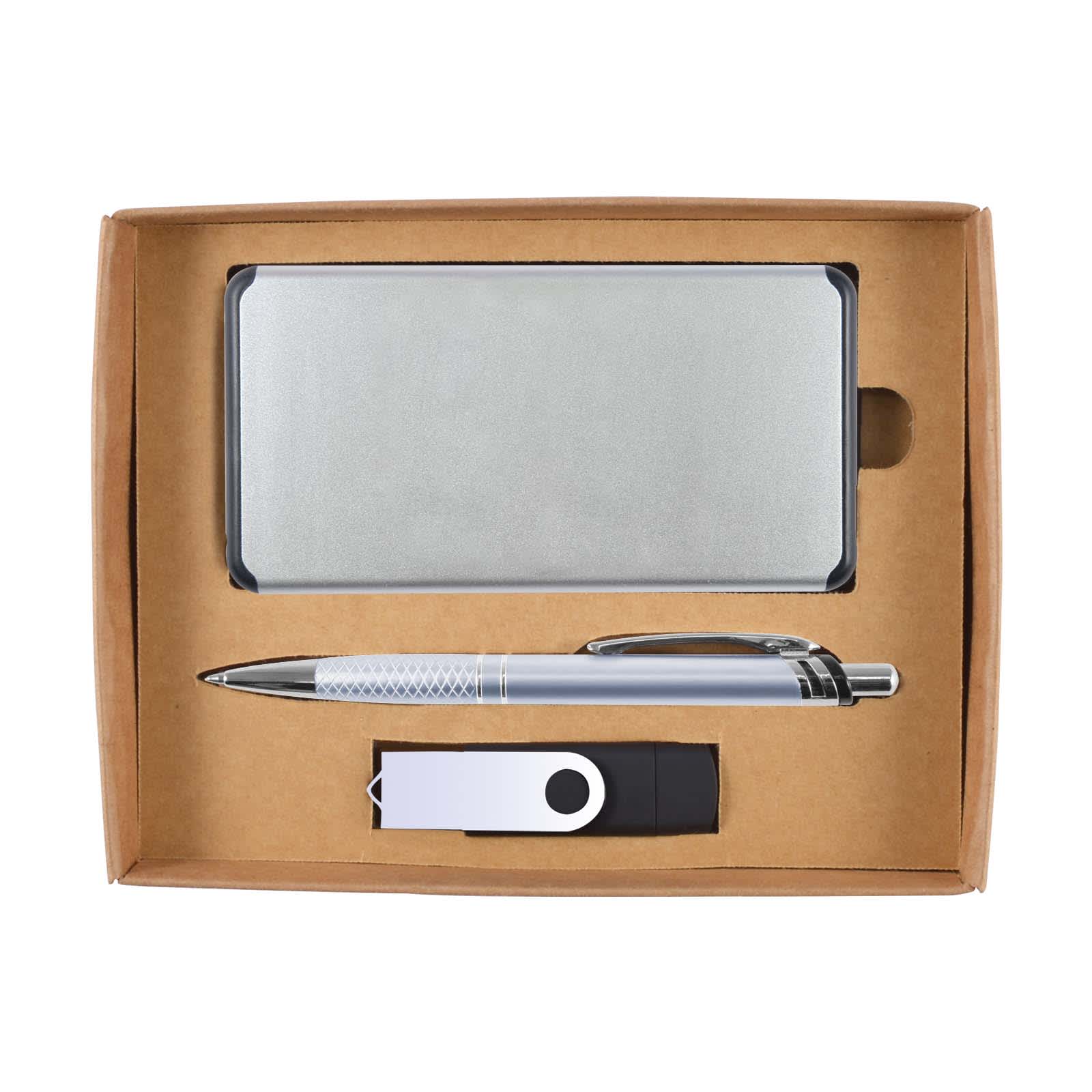 A silver power bank, silver pen, and black USB drive arranged inside a cardboard gift box. The box has a logo.