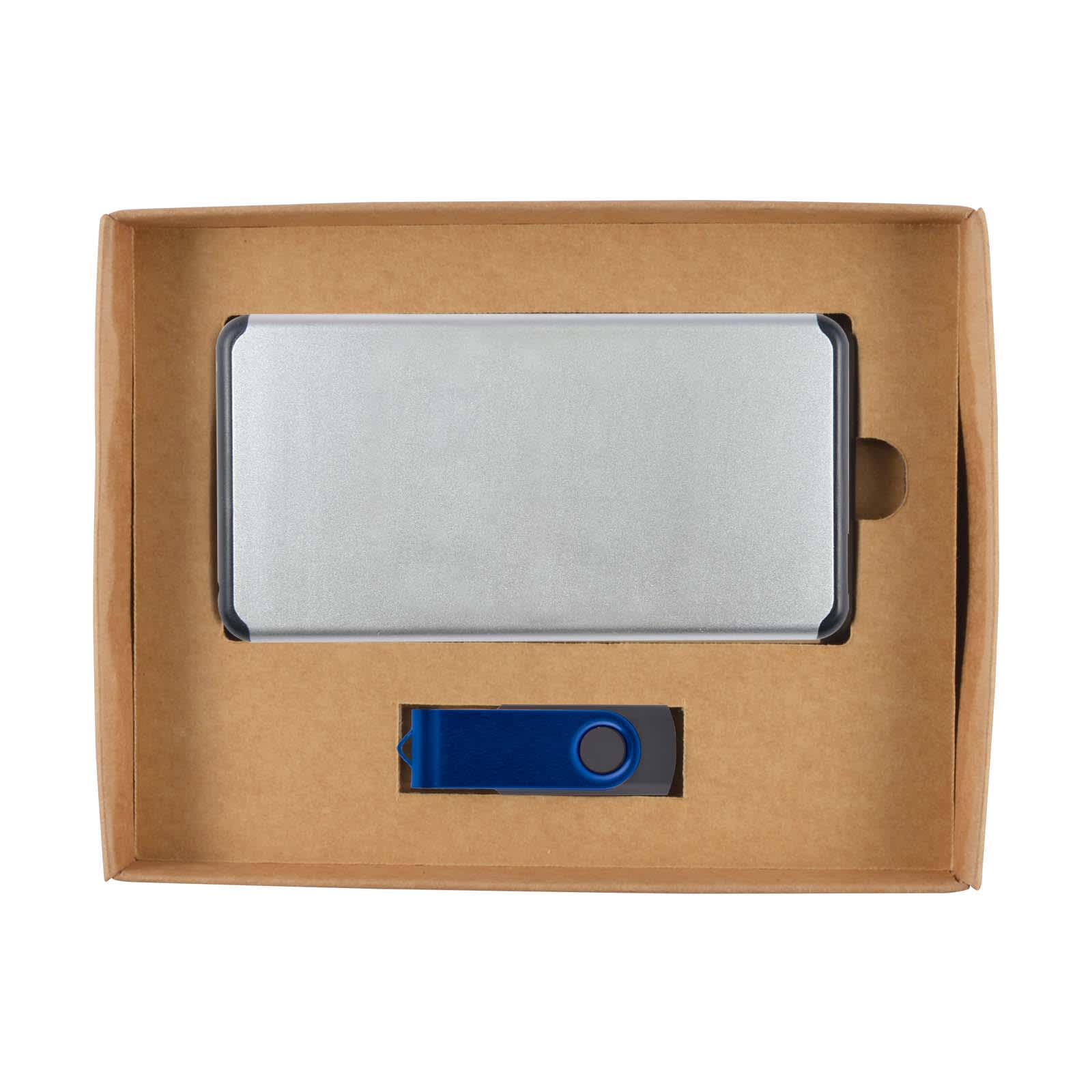 A cardboard gift set containing a silver power bank and a blue USB flash drive.