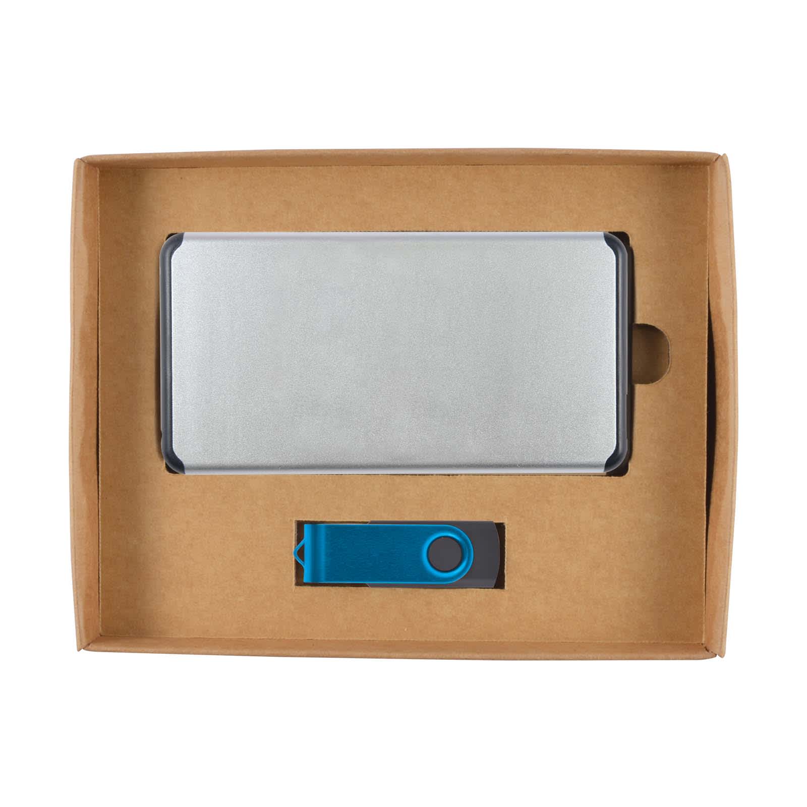 A silver power bank and a blue USB drive, presented in a cardboard gift box.