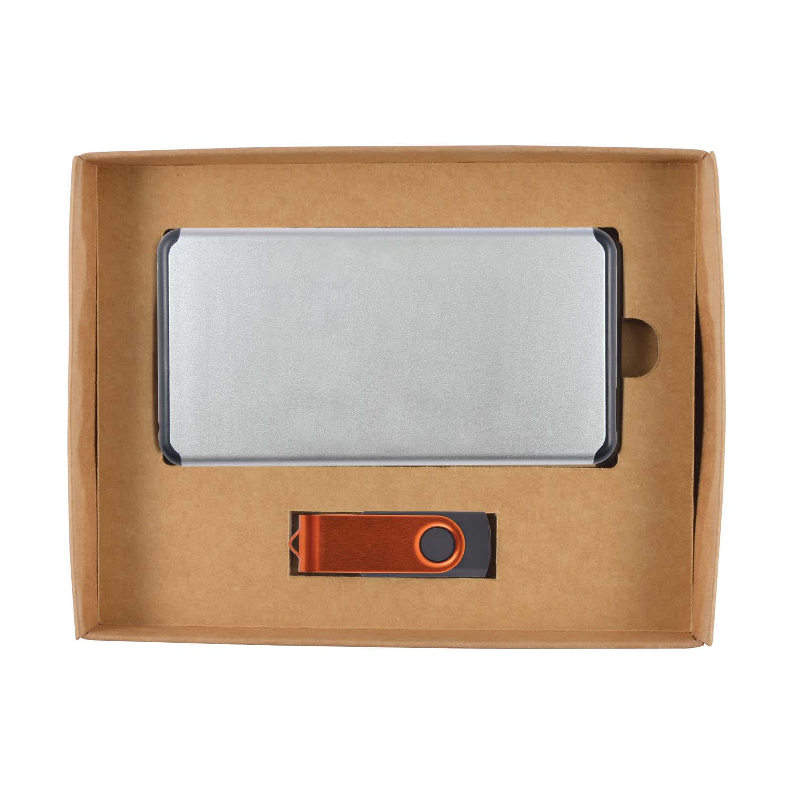 A cardboard gift set containing a sleek power bank and a matching USB drive, both presented in a structured box.