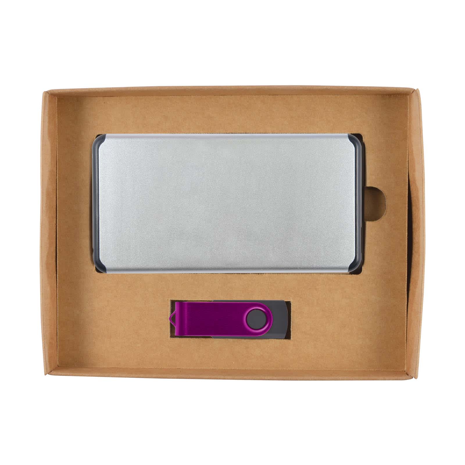 A silver power bank and a purple USB drive packaged together in a cardboard gift box.