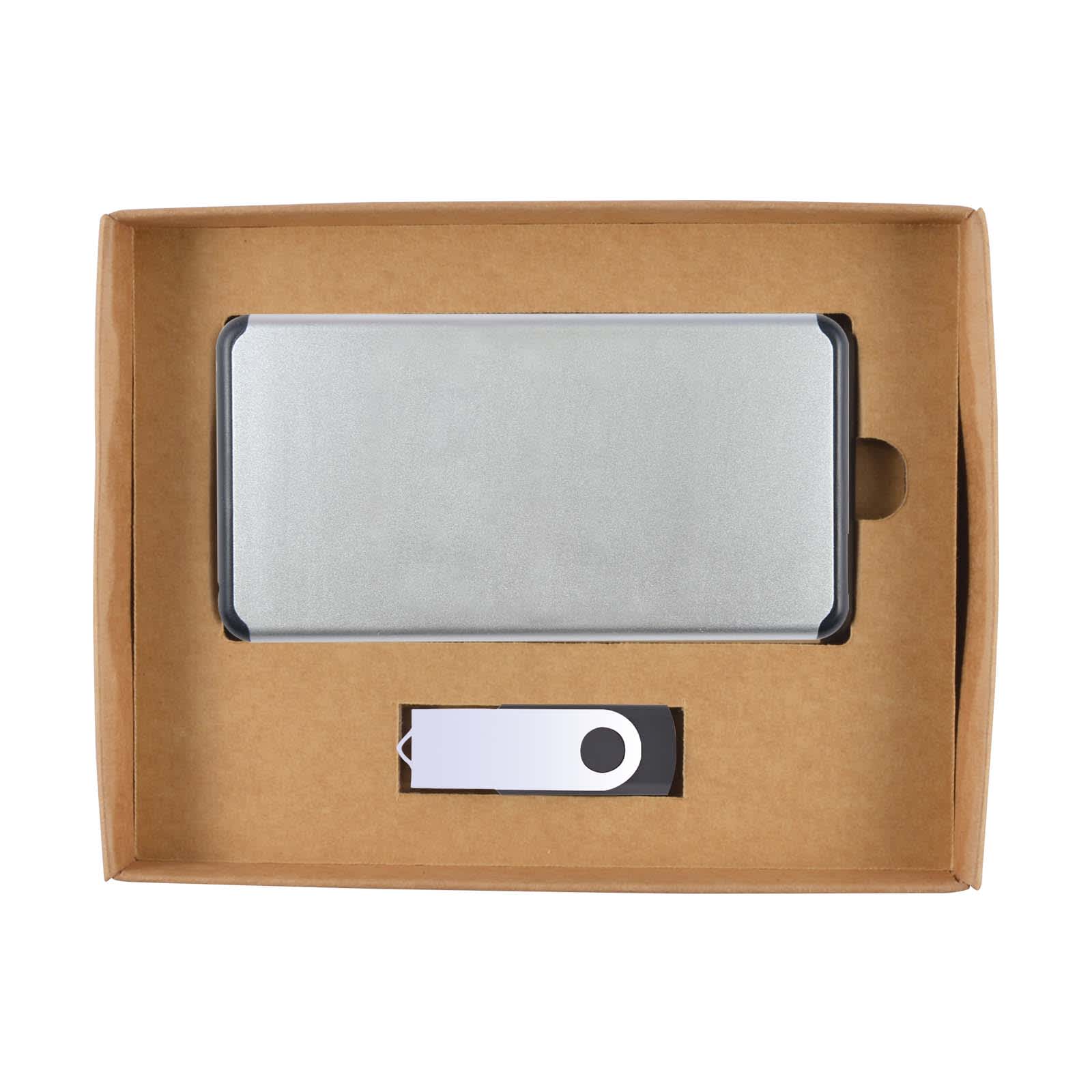 A cardboard gift set featuring a silver power bank and a small accessory, both neatly arranged in a brown box.
