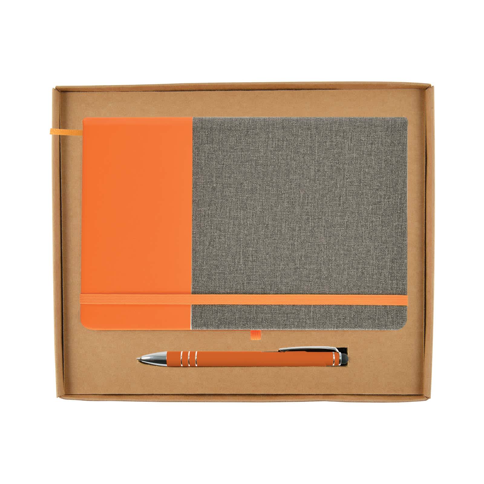 An orange and gray notebook with an elastic band and a matching orange pen inside a cardboard gift box.