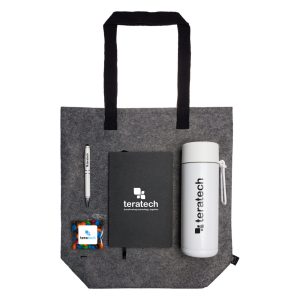 A tote bag in gray felt contains a branded drink bottle, a notebook, a pen, and a small bag of colorful candies.