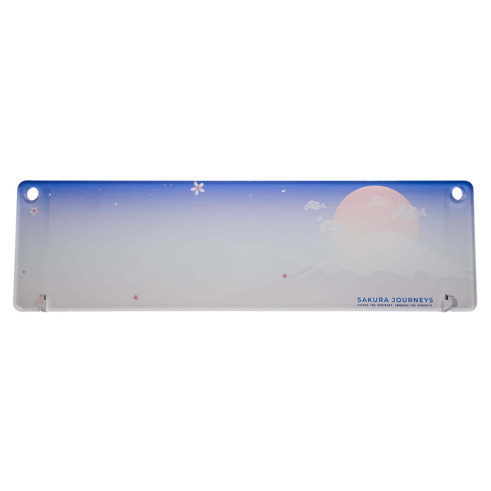 A translucent desk mat featuring a gradient blue and white design with a mountain and sun illustration, plus branding.