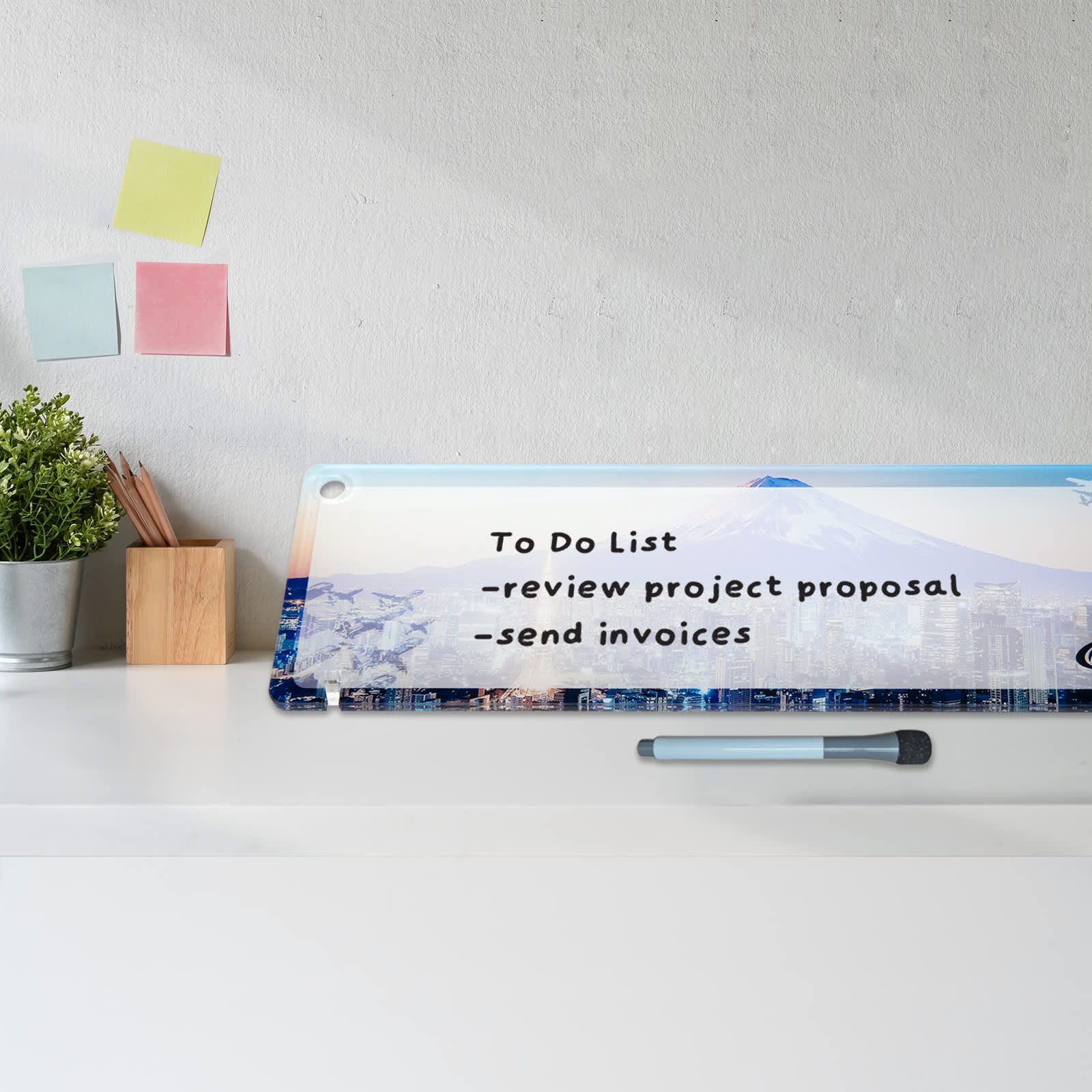A long, translucent desk mat featuring a gradient from blue to white, with pink cherry blossom designs and a circular sun illustration.