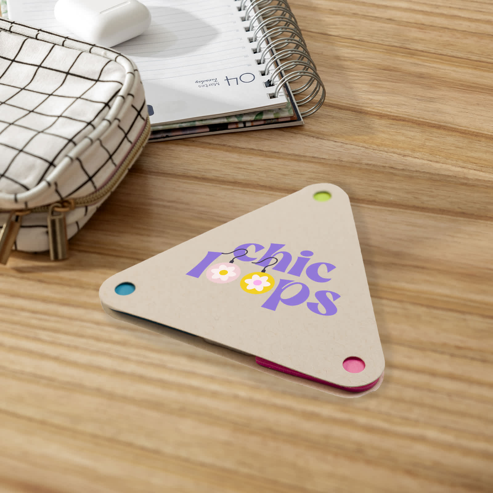 A triangular sticky note pad in beige with colorful corners, featuring the text 