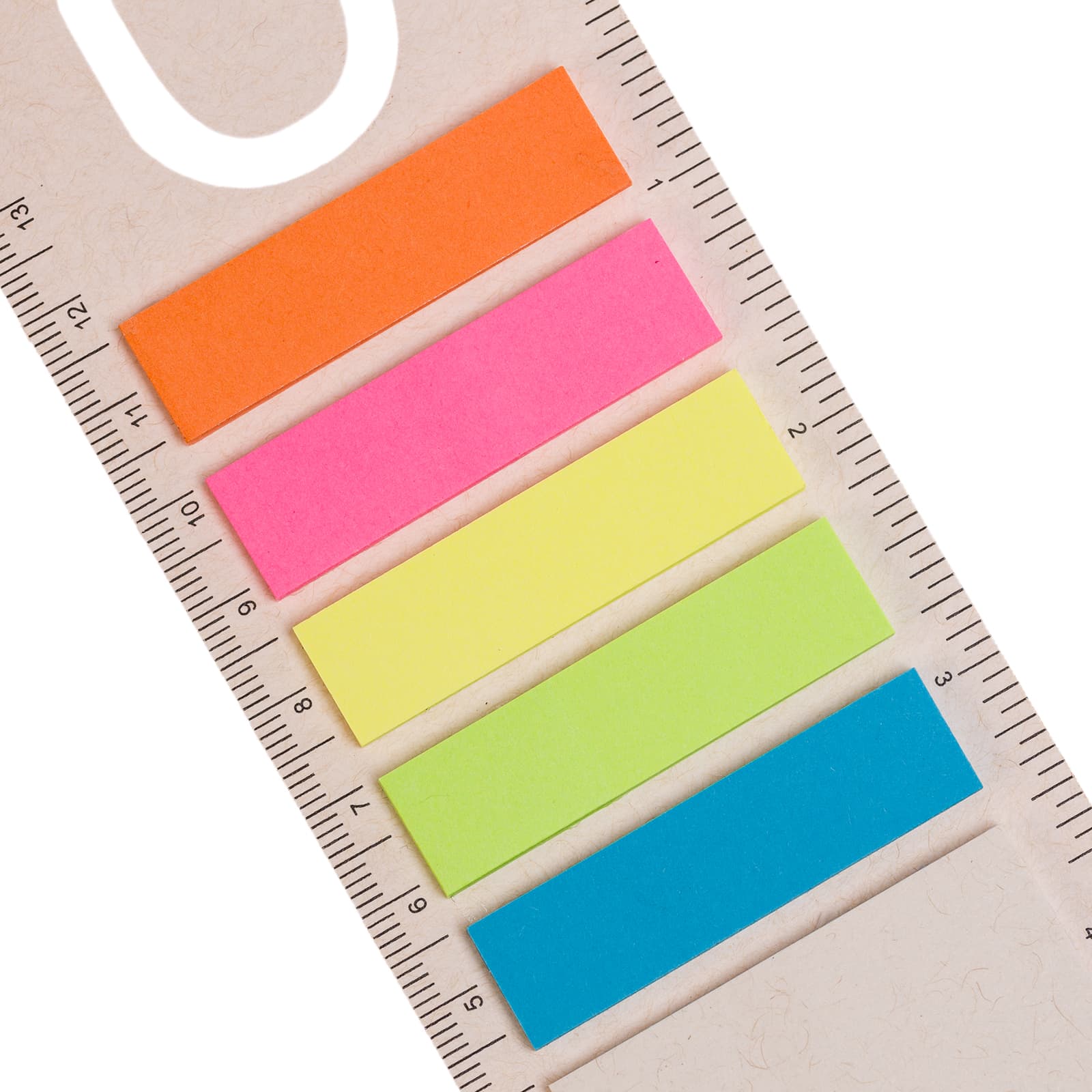 A rectangular ruler features five colorful sticky bookmarks in orange, pink, yellow, green, and blue.