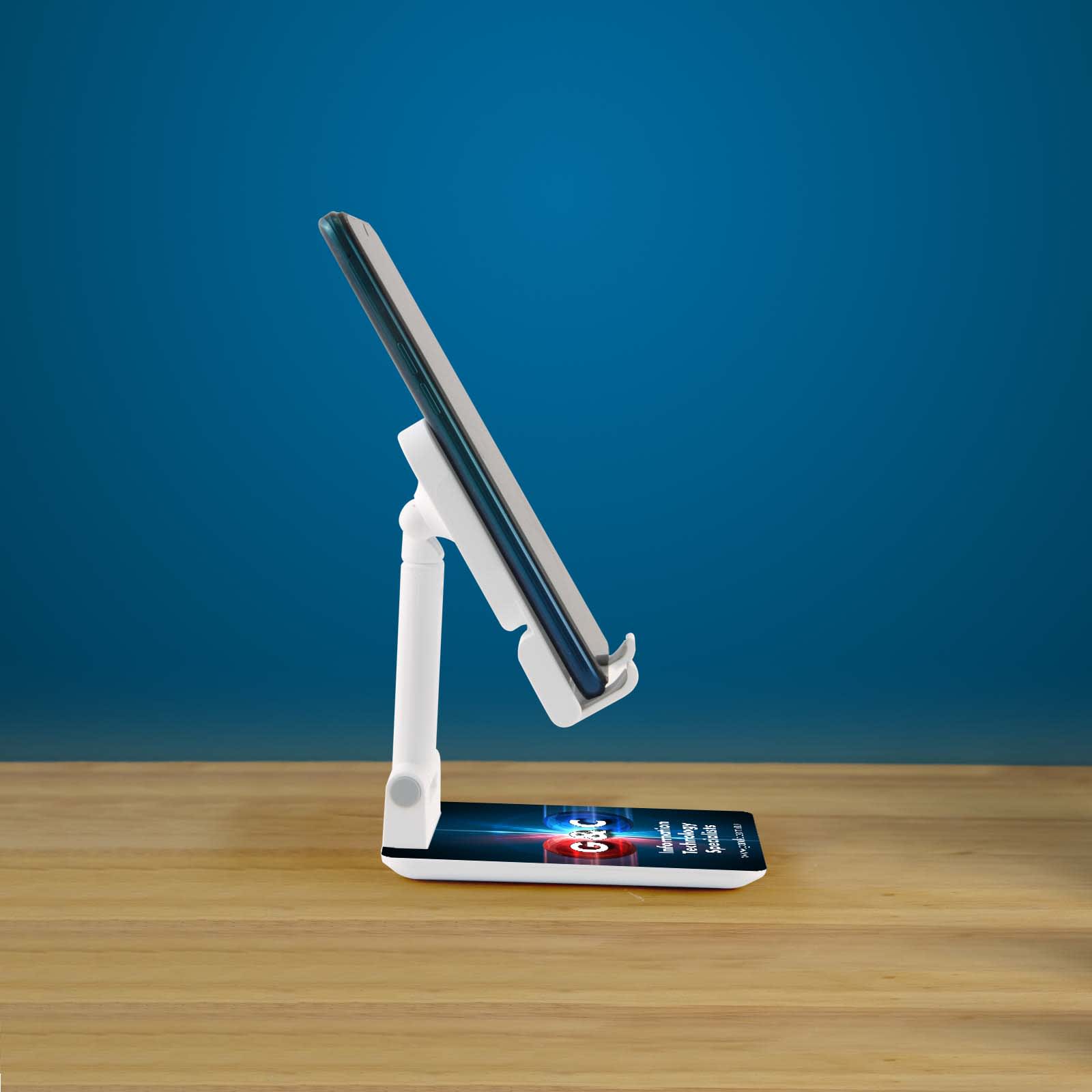 A white phone stand with an adjustable arm supports a smartphone on a wooden surface against a blue background.