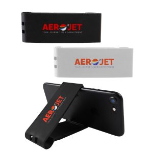 A black and white Grip Clip Phone Stand displayed upright behind a smartphone, featuring a logo on each side.