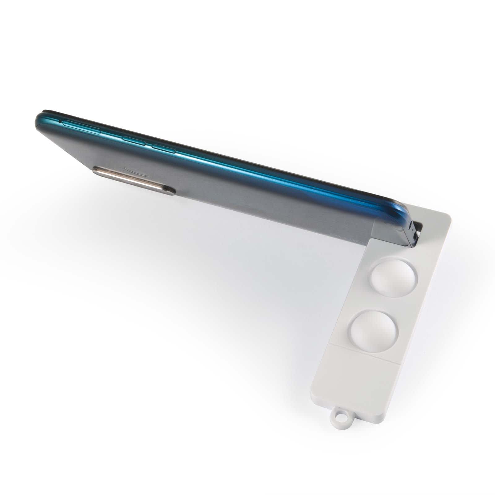 A gray phone stand featuring a sleek design with two circular slots and a logo, supporting a smartphone at an angle.