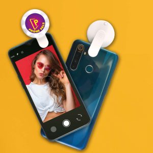 A blue smartphone displaying a selfie with a woman in sunglasses, featuring a white LED selfie light attachment.