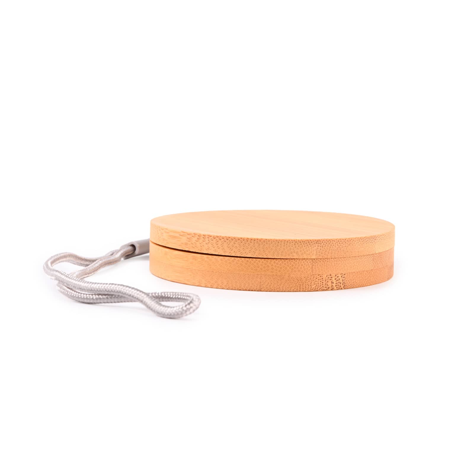 A circular bamboo cable organizer with a textured surface and a grey strap for easy carrying.